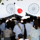 A Japan's national flag flutters among visitors at the Yasukuni Shrine in Tokyo August 15, 2014, on the 69th anniversary of Japan's surrender in World War Two. Japanese Prime Minister Shinzo Abe on Friday sent a ritual offering to the Tokyo shrine to war dead but did not join senior government officials in a visit, a decision meant to avoid inflaming ties with Beijing as he seeks a Sino-Japanese summit.